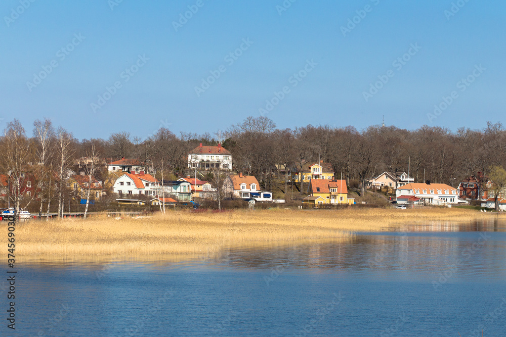 Swedish landscape with houses by the lake Malaren in a sunny day, Sweden.