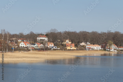 Swedish landscape with houses by the lake Malaren in a sunny day, Sweden.