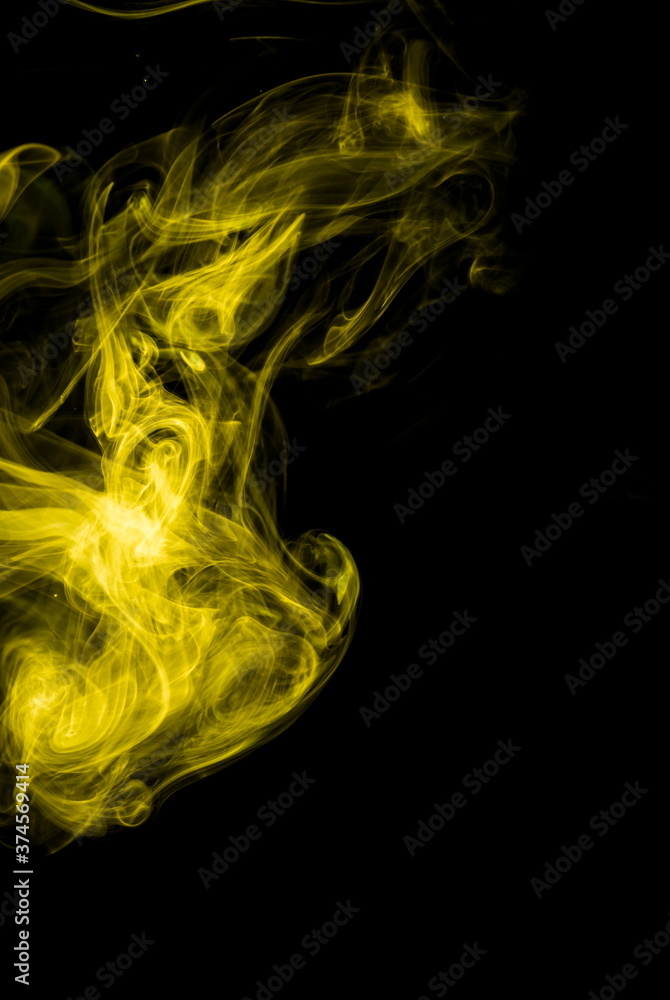 Obraz premium Yellow smoke on black background