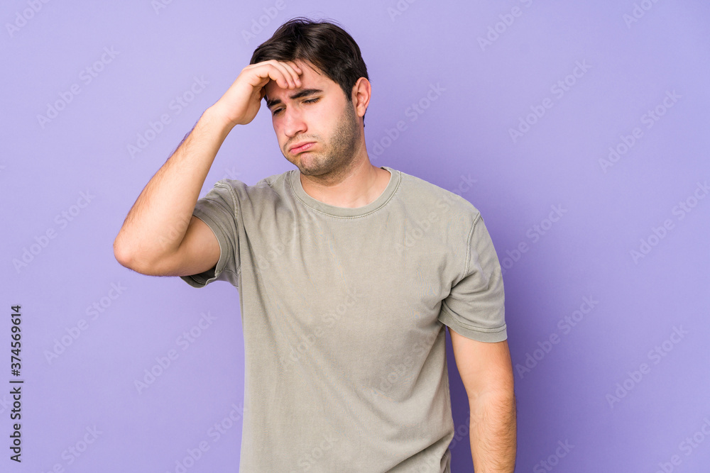 Young man isolated on purple background touching temples and having headache. Young man isolated on purple background touching temples and having headache.