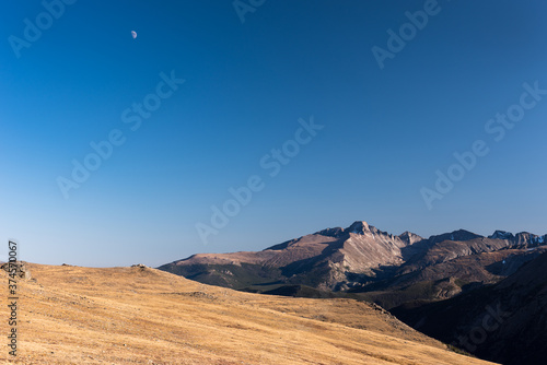Trail Ridge view point of Longs Peak with moon in the late afternoon light. 14,259 foot Longs Peak is the highest point in Rocky Mountain National Park in Colorado. 