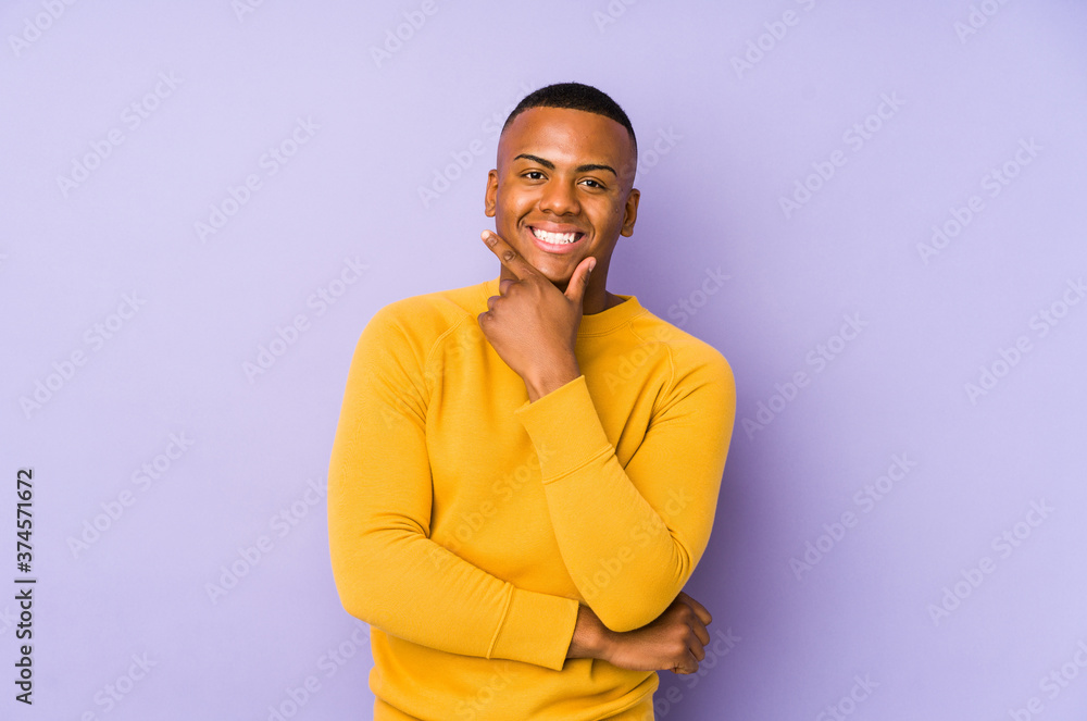 Young latin man isolated on purple background smiling happy and confident, touching chin with hand. Young latin man isolated on purple background smiling happy and confident, touching chin with hand.