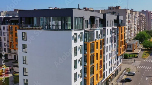 Contemporary residential building in the city. Exterior of a modern design of multistorey apartment building. Aerial view. photo