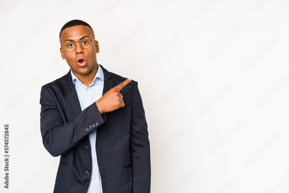 Young business latin man isolated on white background pointing to the side Young business latin man isolated on white background pointing to the side