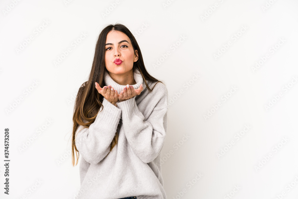 Young caucasian woman isolated on a white background folding lips and holding palms to send air kiss. Young caucasian woman isolated on a white background folding lips and holding palms to send air kiss.