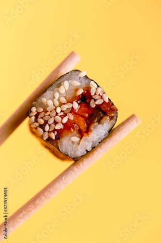 fresh sushi on sticks on a yellow background