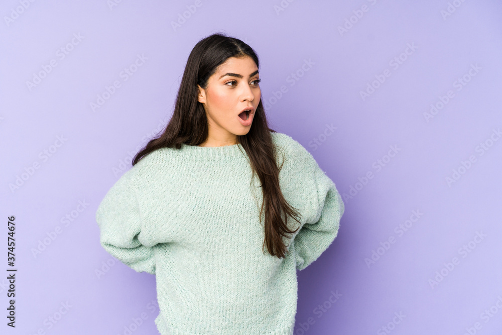 Young indian woman isolated on purple background being shocked because of something she has seen. Young indian woman isolated on purple background being shocked because of something she has seen.