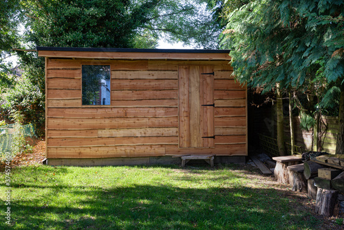 Fotografie Waney edge wooden rustic garden shed.