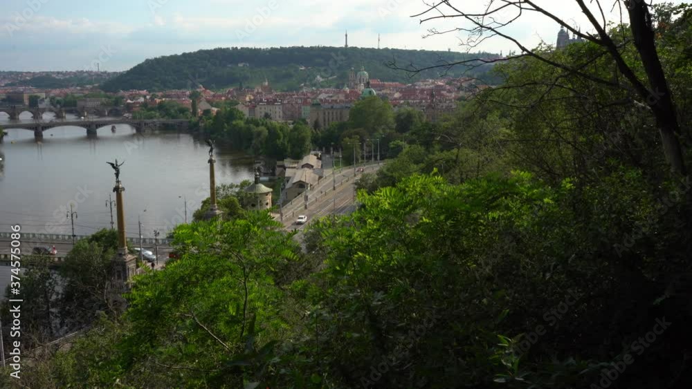 
view of the flowing Vltava river and the bridges on it and the Charles Bridge from the 14th century in the center of Prague from the 14th century during the day