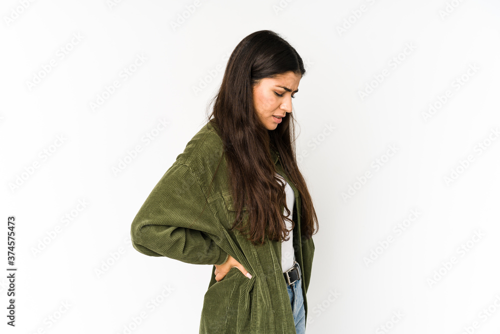 Young indian woman isolated on purple background suffering a back pain. Young indian woman isolated on purple background suffering a back pain.