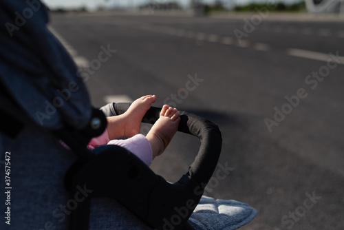 on  roadway there is a stroller with  child