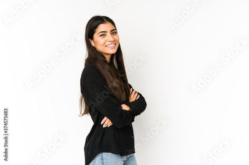 Young indian woman isolated on purple background who feels confident, crossing arms with determination. © Asier