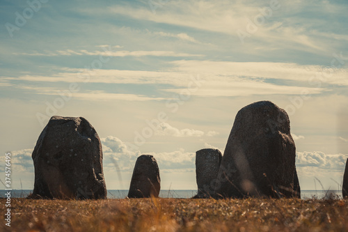 Ale Stones (Ales stenar) Is a megalithic monument of 59 large boulders and is 67 meters long. This landmark is located in Kåseberga, Sweden. Selective focus. photo