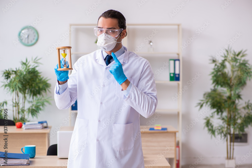 Fototapeta premium Young male doctor virologist in the office