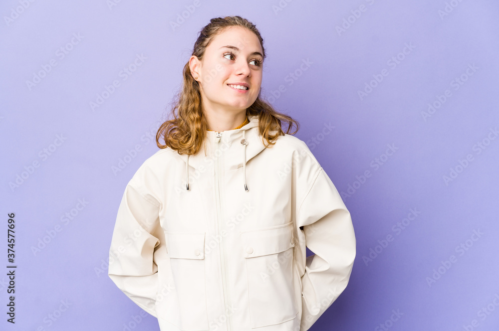 Young caucasian woman on purple background relaxed and happy laughing, neck stretched showing teeth. Young caucasian woman on purple background relaxed and happy laughing, neck stretched showing teeth.