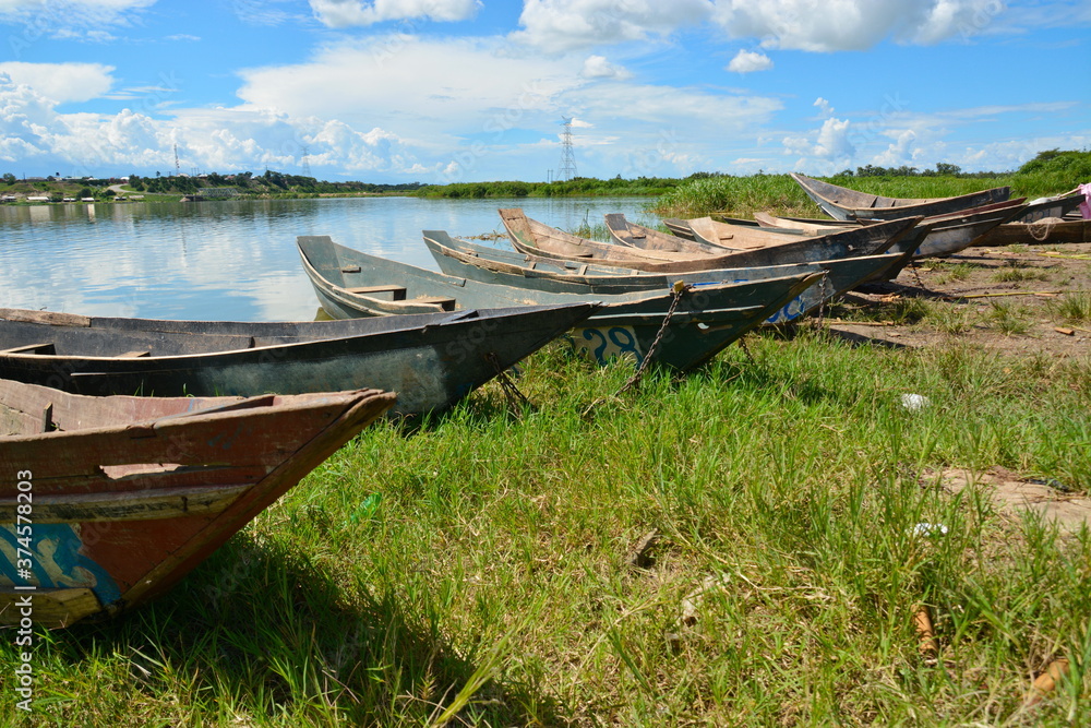 Wooden boats on the shore of Lake Victoria, Uganda, against a bright blue sky. Wooden boats on the shore of Lake Victoria, Uganda, against a bright blue sky.