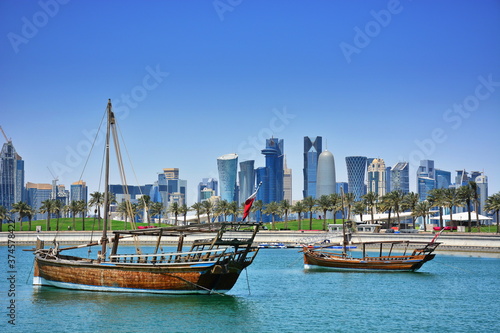 Dhow boat harbored against the city skyline of West Bay in Qatar.