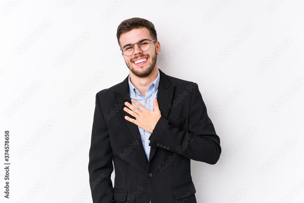Young caucasian business man posing in a white background isolated Young caucasian business man laughs out loudly keeping hand on chest. Young caucasian business man posing in a white background isolated Young caucasian business man laughs out loudly keeping hand on chest.