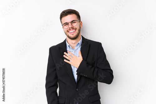Young caucasian business man posing in a white background isolated Young caucasian business man laughs out loudly keeping hand on chest.
