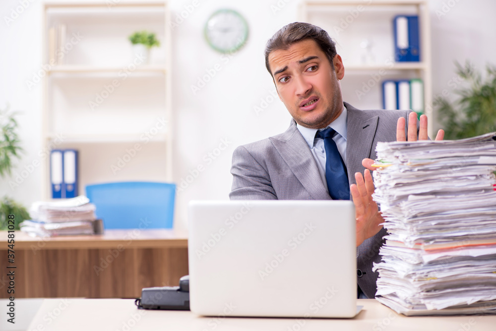 Young male businessman unhappy with excessive work Young male businessman unhappy with excessive work