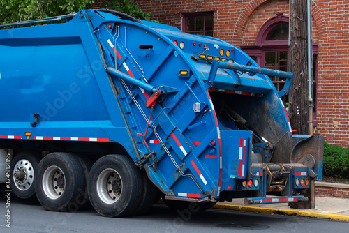 garbage truck collecting trash garbage truck keeping garbage on urban street