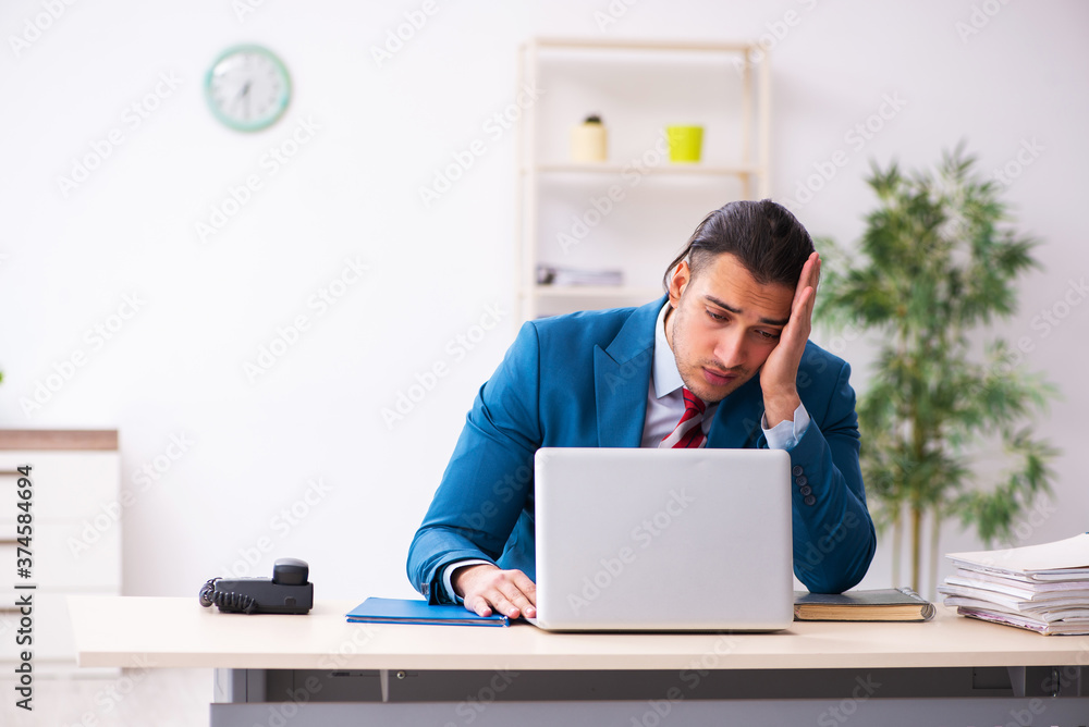 Sick male employee suffering at workplace from coronavirus Sick male employee suffering at workplace from coronavirus
