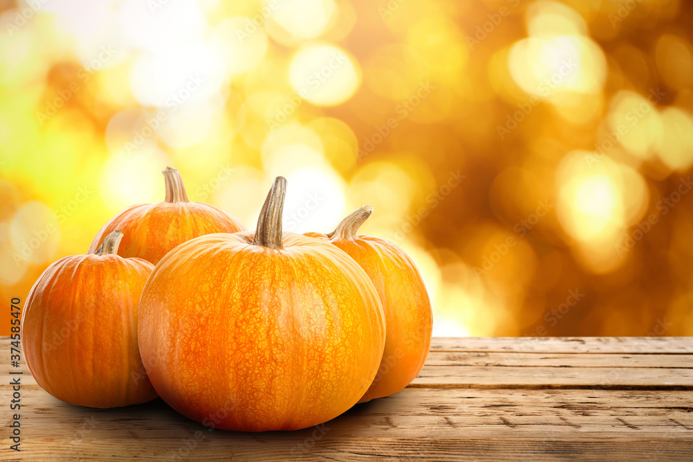 Fresh pumpkins on wooden table outdoors in autumn. Space for text Fresh pumpkins on wooden table outdoors in autumn. Space for text