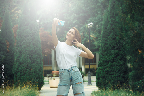 Young attractive hipster girl making selfie