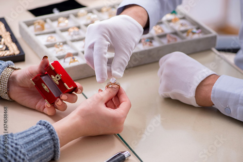 Foto Male jeweler and female client at store