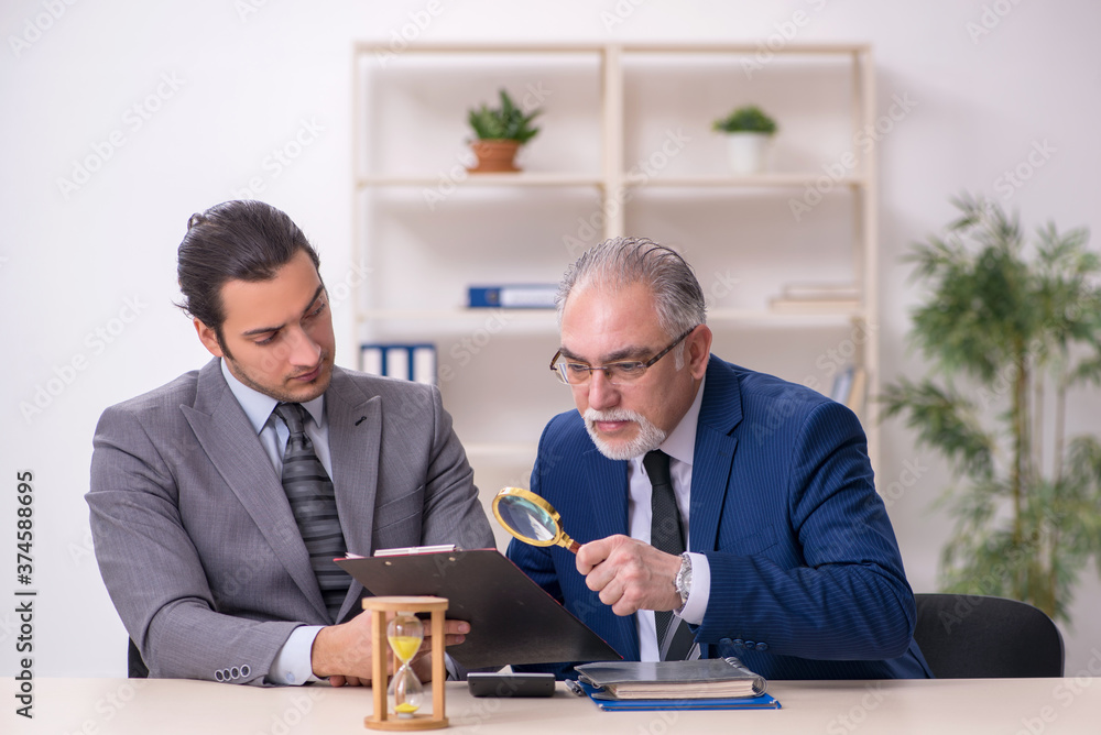 Two businessmen in time management concept Two businessmen in time management concept