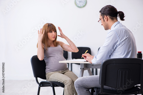 Pregnant woman visiting male psychologist doctor © Elnur
