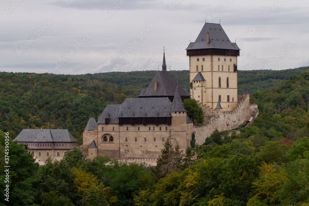  Karlstein is a medieval royal castle, in the Czech forests and countryside during the day