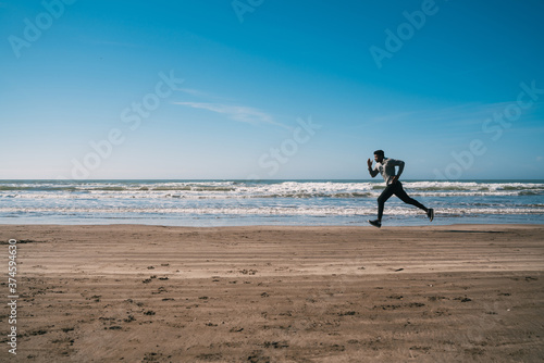 Portrait of an athletic man running.