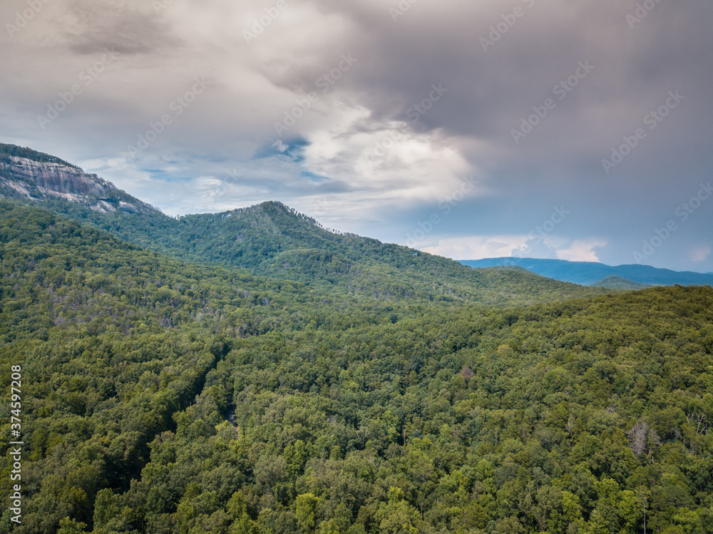 Landscape with mountains and forest. Thunderclouds in the sky. Forest good for hiking trails