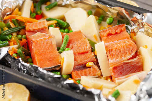 Foil pack dinners. Salmon with vegetables in foil. Dietary food.