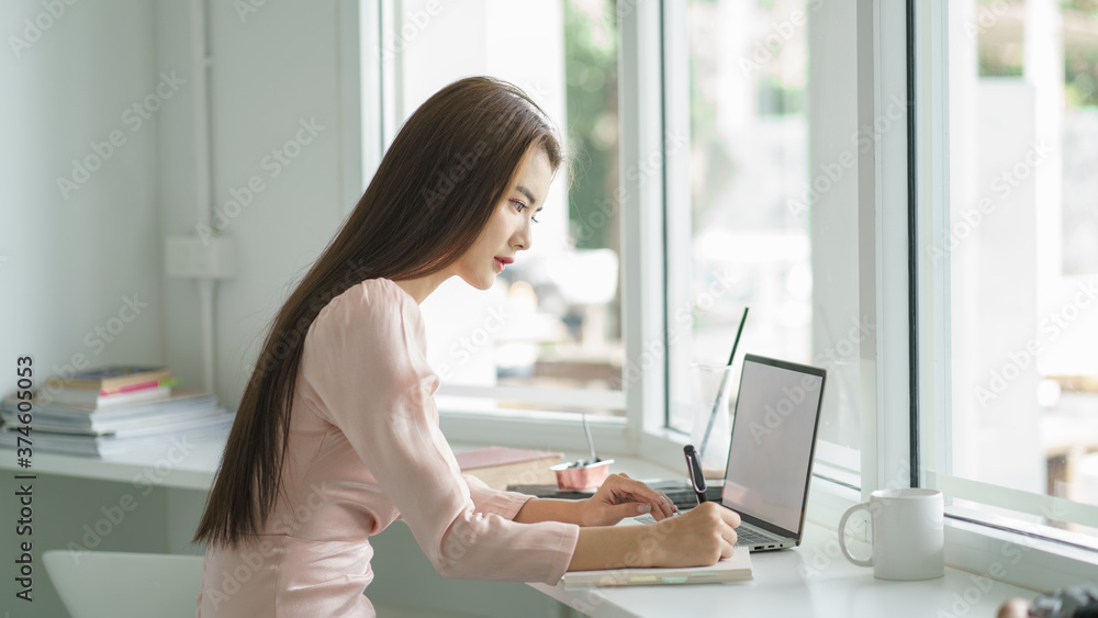 Portrait of young businesswoman watching at laptop and smiling. Portrait of young businesswoman watching at laptop and smiling.