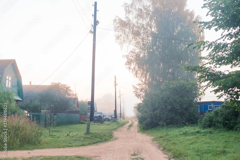 Rural landscape on a early foggy morning in the village.
