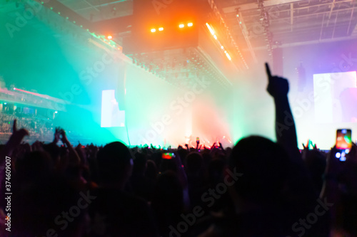 concert playing in a crowded hall with the lights in the dark and the noise in the blur