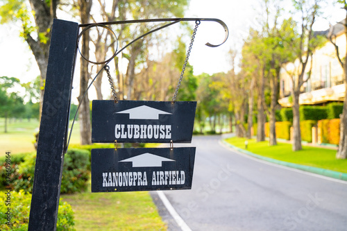 A sign to the clubhouse in a bright morning, perfect for a family vacation photo