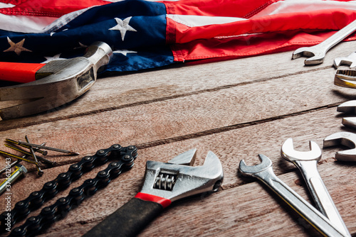 Fotografie USA Labor day concept, Top view flat lay of different kinds wrenches with American flag on wood table
