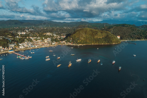 parking of ships.city port.Wild islands of Indonesia. Flores tropical paradise. Labuan Bajo. drone shooting. Wild beaches, blue logons, coral reefs, green hills. aerial view. boat trip safari. harbor 