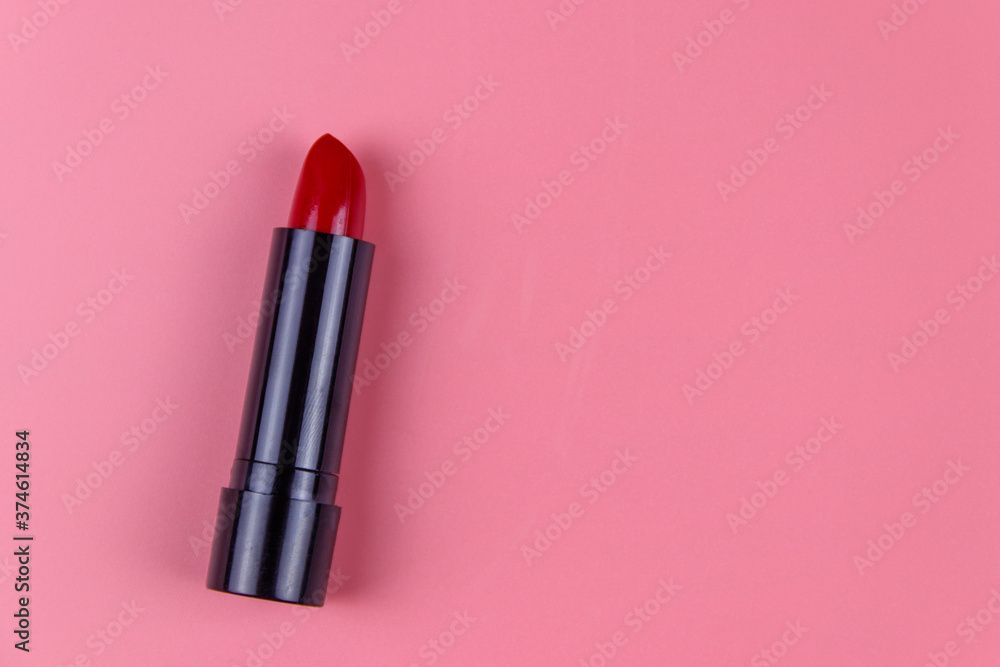 Red lipstick on a pastel pink background. Top view, copy space Red lipstick on a pastel pink background. Top view, copy space