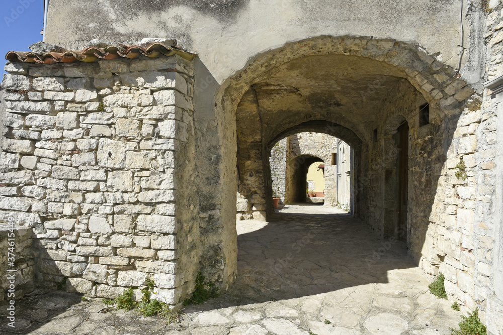A narrow street among the old houses of Cercemaggiore, a rural village in the Molise region. A narrow street among the old houses of Cercemaggiore, a rural village in the Molise region.