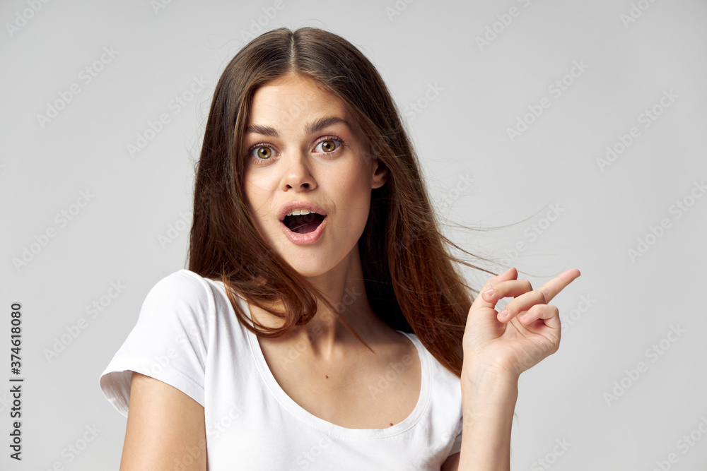 woman with open mouth surprised look emotions gesture Finger to the side Copy Space woman with open mouth surprised look emotions gesture Finger to the side Copy Space