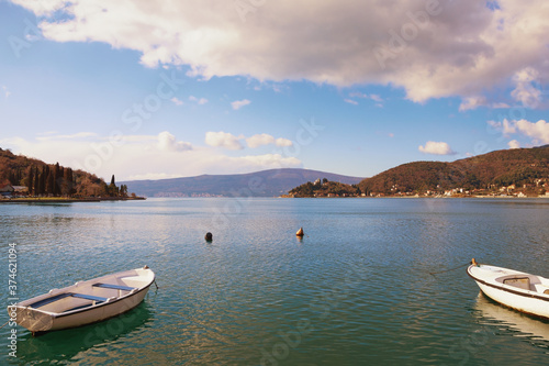 Sunny winter Mediterranean landscape. Montenegro, Adriatic Sea. View of Kotor Bay and fishing boats on water