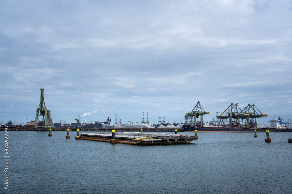 container ships with cranes in the harbor of rotterdam netherlands