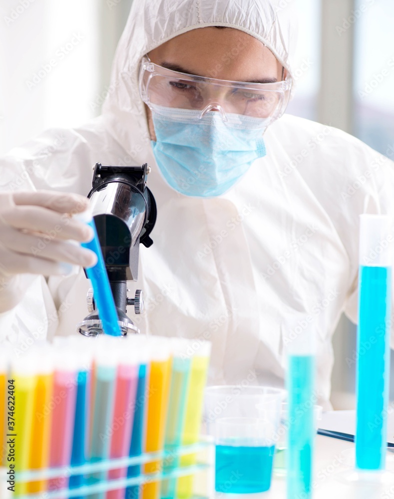Young chemist student working in lab on chemicals Young chemist student working in lab on chemicals