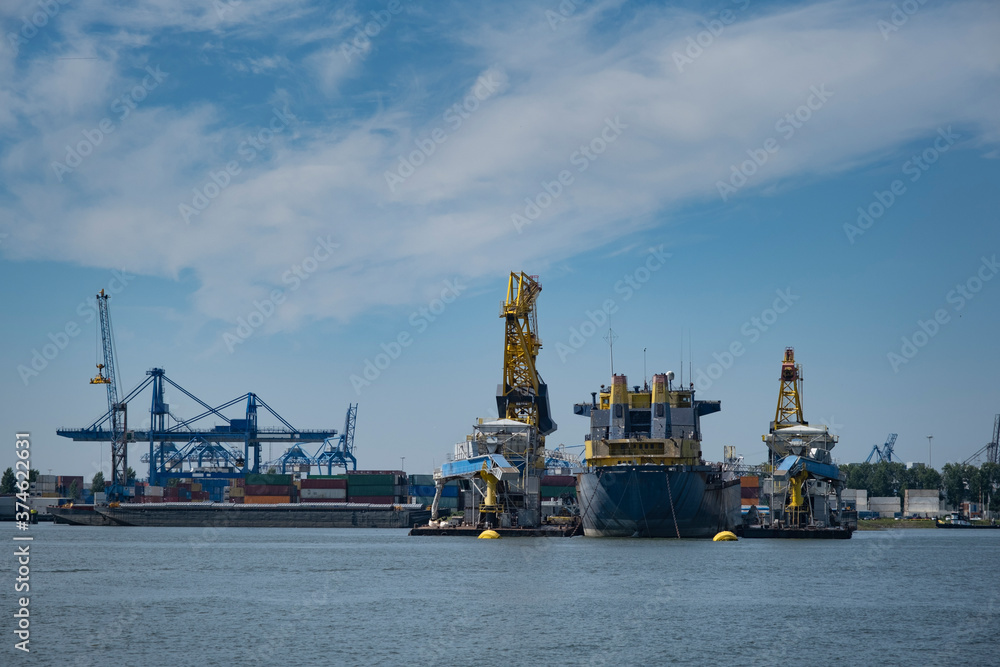 container ships with cranes in the harbor of rotterdam netherlands