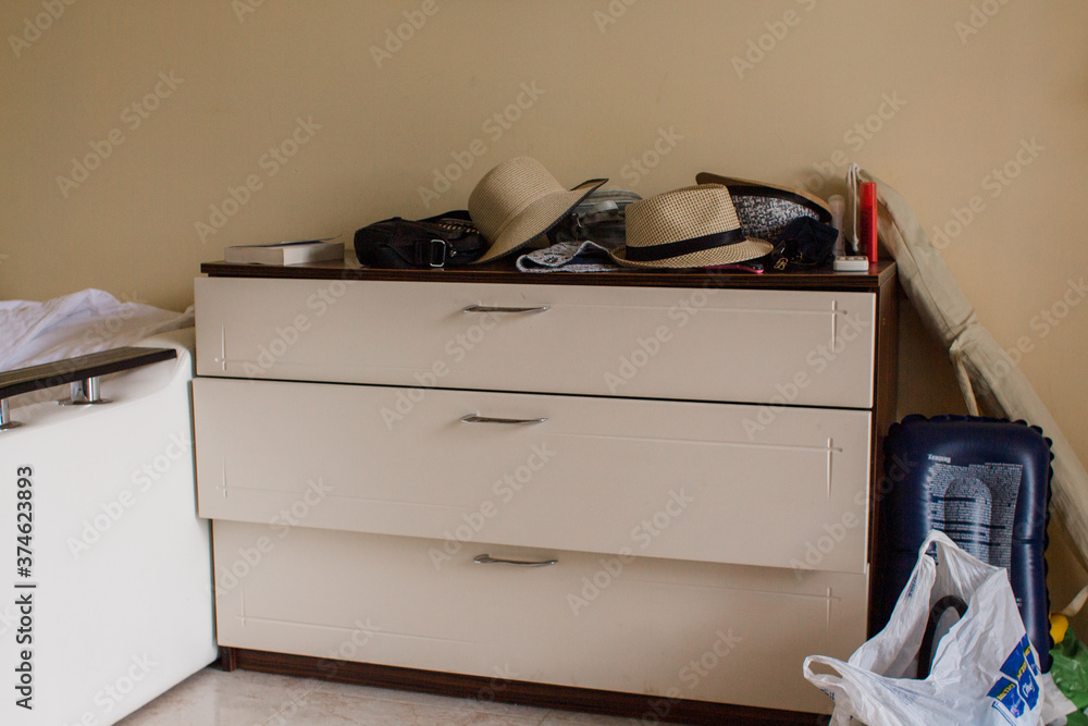 Fototapeta premium large chest of drawers in the room with things