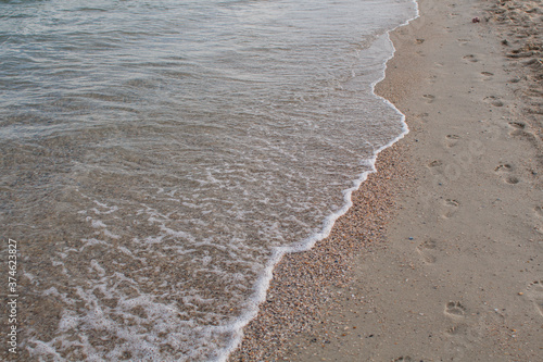 sandy seashore with clear sea water